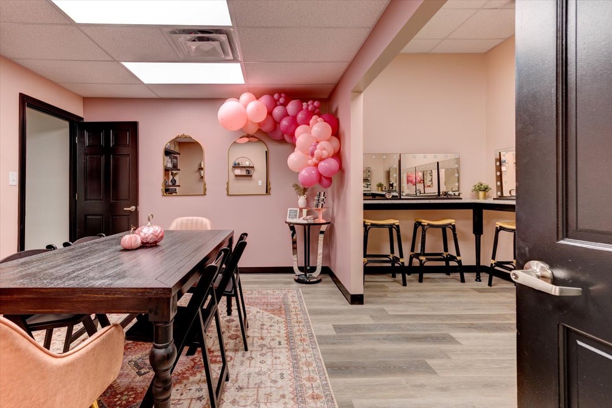 pink room with dining table and balloon display