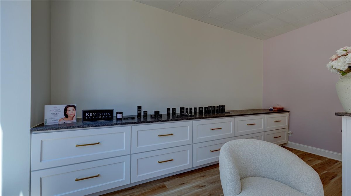 A dental office waiting room with light pink walls.