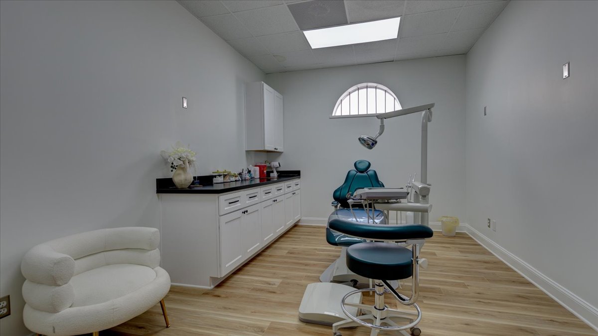 A dental exam room with a blue chair.