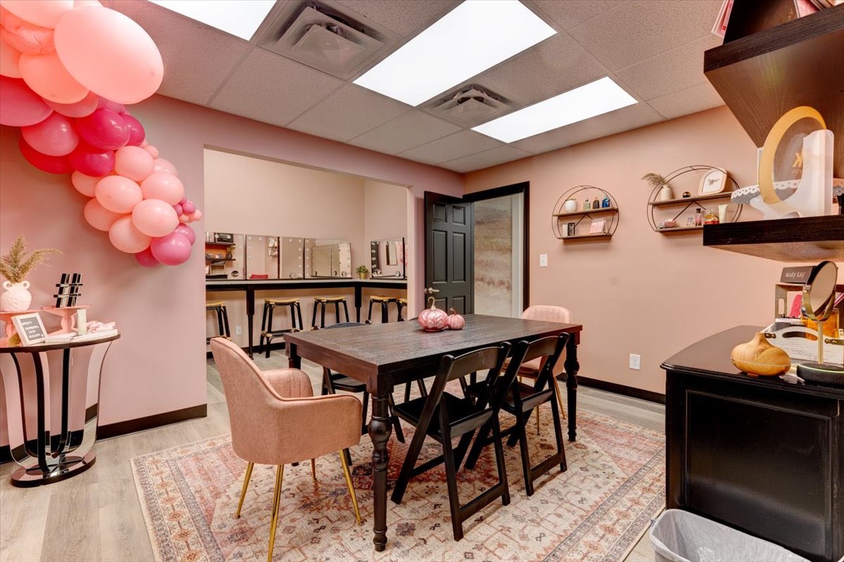 Ann office room with pink walls and balloons for a celebration.